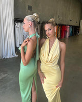 Alice Dress by Lexi, in butter yellow colour, deep cowl neckline, luxe satin fabric, halter tie-up back with adjustable strap, sleek straight fit with back split. Hire for weddings, special events, formal events, school balls.