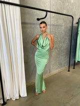 Alice Dress by Lexi, in kiwi green colour, deep cowl neckline, luxe satin fabric, halter tie-up back with adjustable strap, sleek straight fit with back split. Hire for weddings, special events, formal events, school balls.